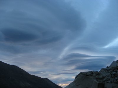 more cool lenticular clouds on a cloudy dawn