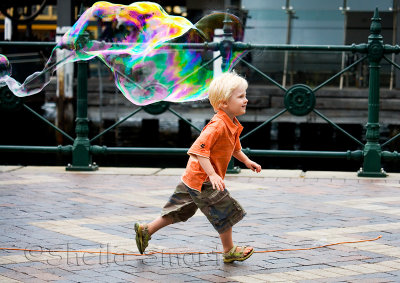 Boy running with bubble