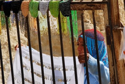 A young woman displays her items for sale in Saqqara.