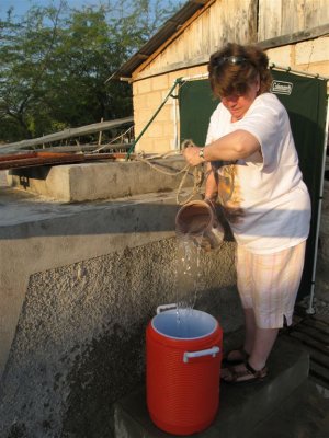 Jean collecting water to wash with