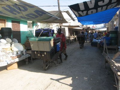 taking our supplies from the boat to the truck through the market