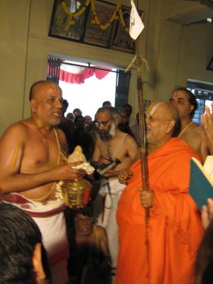 Srikaryam Sri Ananthrangachar Swami is giving Poorna Kumbha Mariyade to H H Andavan Swami