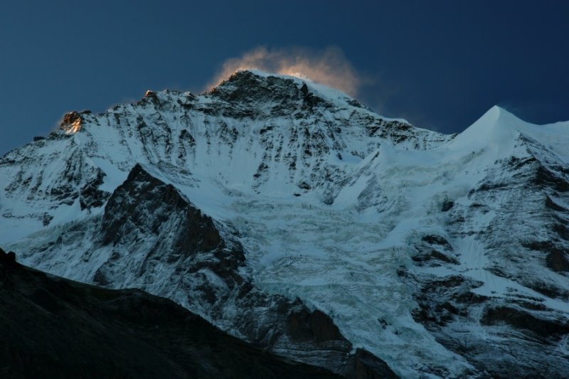 The first sunlight hits the summit of the Jungfrau