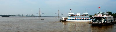 Ferries and new My Tho Bridge crossing Mekong River