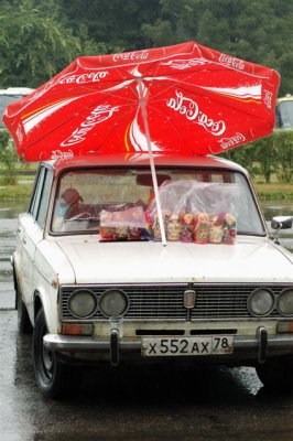 Russian Vendor Keeps Dry With Coke Umbrella