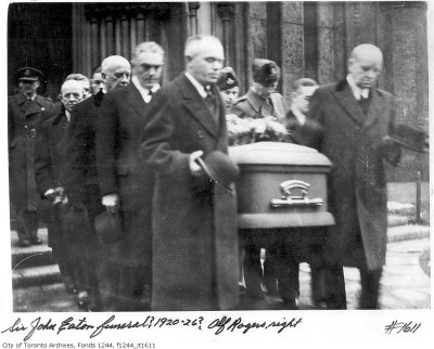 I DOUBT THAT THE EATON FUNERAL, IS AS SUGGESTED.

(SIR JOHN EATON'S FUNERAL.)

1) MID, TO LATE '30s.

2) CLOTH COVERED COFFIN.

3) SERVICE NOT AT THE TIMOTHY EATON CHURCH.

4) LADY EATON/JOHN JR NOT TO BE SEEN.

NOTE: OF THE TWO MEN FACING EACH OTHER, WILLIAM (BILL) MILES

IS ON THE LEFT (ALFRED ROGERS BEHIND HIM) AND MILES' OWN

COACH DRIVER IS ON THE RIGHT.