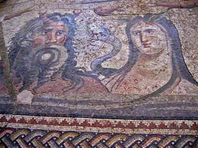 Double lobsters are tied to his hair while Thetis has double wings on her head.  The river
dragon is between them. This mosaic was found on the floor of a shallow pond surrounded by columns.