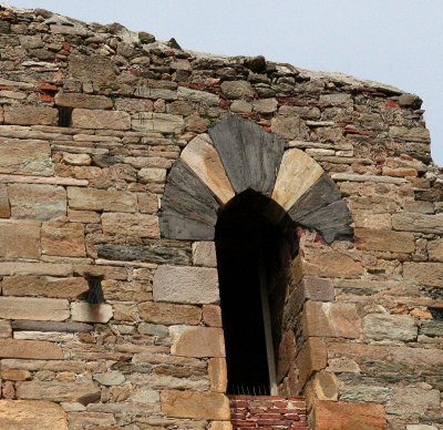 Bars at upper left and spikes that held something above the brick