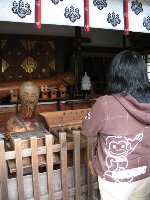 Praying at the smaller shrine