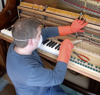 Lawrence Sudweeks of Pocatello's Piano Gallery repairing our piano _DSC0112