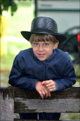 Amish boy on the fence