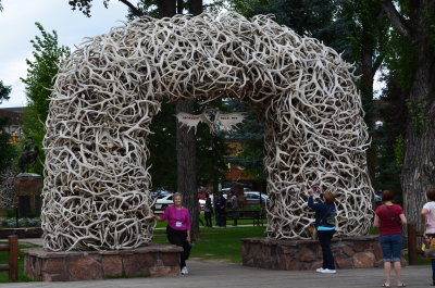 Sheila standing underneath one of the four antler arches downtown