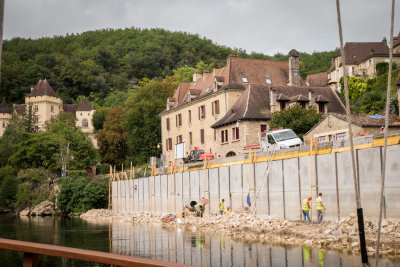 Workmen build protective wall.  