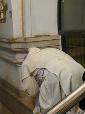 Praying Priest with Cell Phone