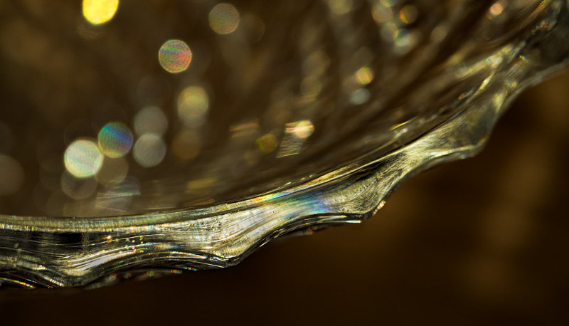 Empty Galway Irish crystal vase on brown tablecloth in late sunlight