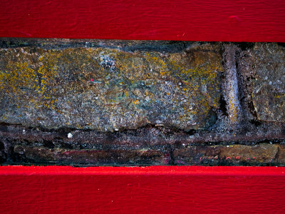Red bench against wall.