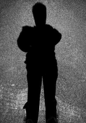 My shadow standing in my shoes.