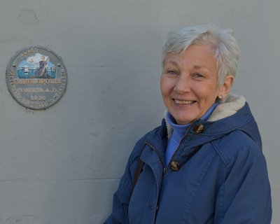 Carol next to Award on side of building