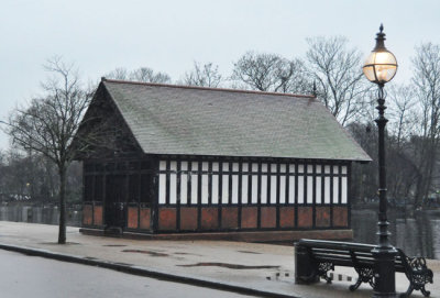 Old rowing shed in January rain