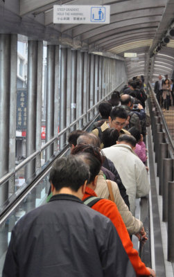 Chinese tourists on escalator to SoHo