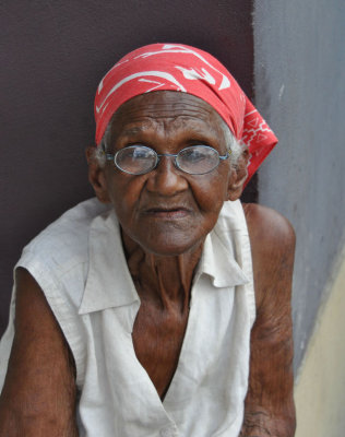 A sad old woman on the Prado
