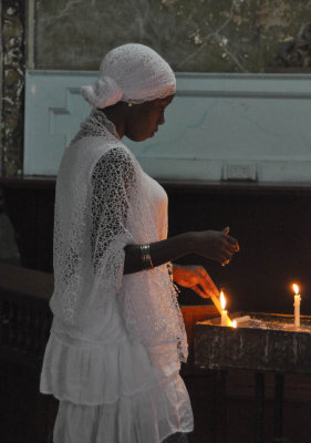 Lighting candle at Habana Cathedral
