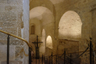 From the portico steps lead down to the low arched nave