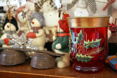 Holly mug and decorations on the fireplace mantle.