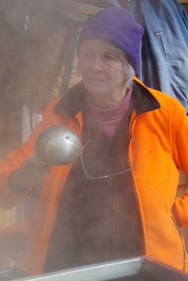 Nancy with ladle, seen through vapors.