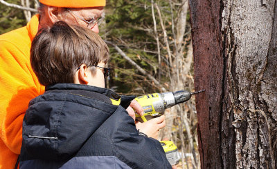 David with helper, drilling a tap.