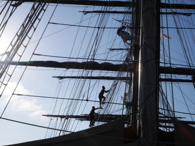 Men going up to put the sails up
