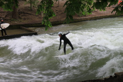 The Eisbach, a small man-made river, forms a standing wave about 1 meter high, which is a popular river surfing spot.