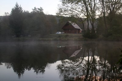 Morning's fog clears up on the fishing pond