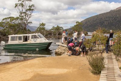 Lots of hikers and a small boat 