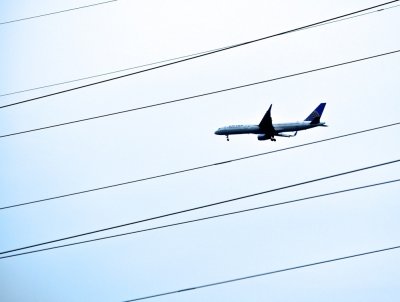 An Airplane Flying Through Lines