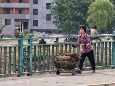 Woman pushing a cart, Pyongyang