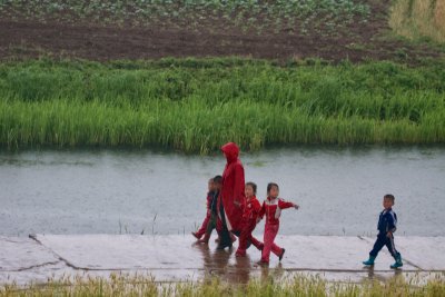 Woman and children walking in the rain