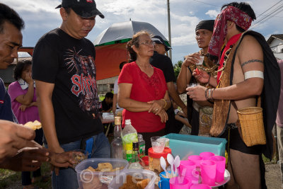 Villagers offering food and drinks to everyone