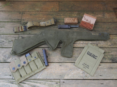Additional accouterments showing 5-cell and unissued USMC 1944 dated 3-cell pouch, belt, and repro ammo boxes