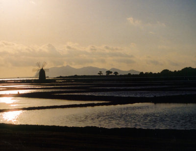 Windmill and salt pans at sunset
