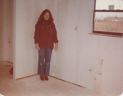 Mary stands in the northeast corner of the kitchen, where the first section of cabinets will be installed.