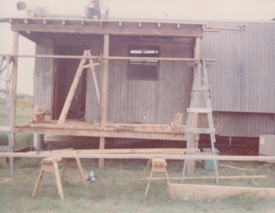 Applying the decking on the roof of the back porch.