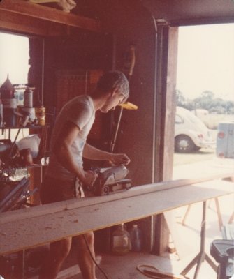 Back in Mustang, Steve sands pieces for the railing of the staircase.