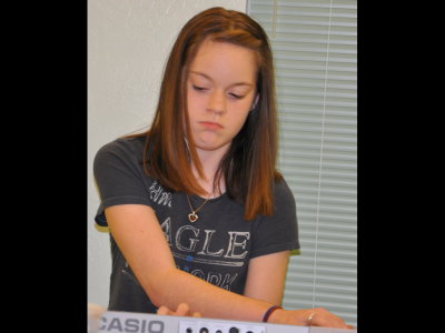 Catherine concentrates on the complicated piece she's playing.