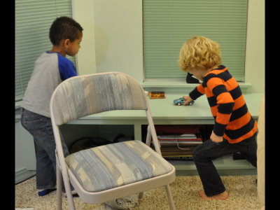 Joseph and Pierce enjoy the 'race track' that is the sunroom window bench.