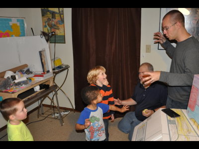 Daniel and Wil lead some of the kids in a game of Simon Says in the front room.