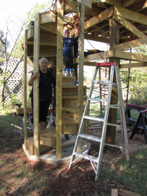 Jackie inspecting Steve's work on the spiral staircase leading to the observation platform in the back yard