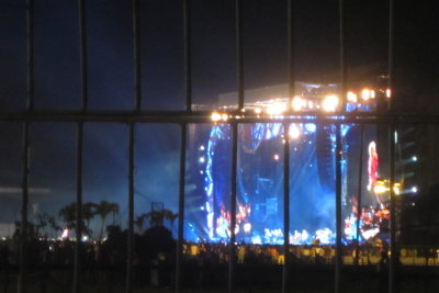 Onlookers, the Rolling Stones on stage and the giant projection screen
from behind the fence at the back of the Ciudad Deportiva, Havana, Cuba, concert
Friday, March 25, 2016