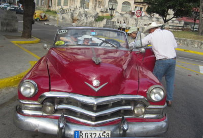 For our Saturday tour of Old Havana, Yuri surprised us with vintage taxis.
Rich, Lorraine and Marnelle
climb into a 50s vintage Cadillac
Havana, Cuba, March 26, 2016