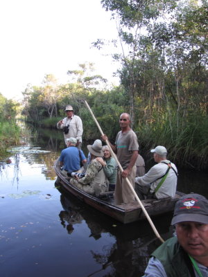 Frank, standing in the bow of the lead boat, John, Bob, Carli, their gondolier, Doug, Paulino, in the bow of our boat.